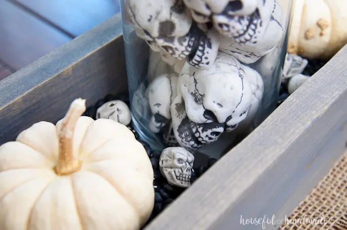 This is the perfect combination of spooky and farmhouse decor. Decorate your dining room table with this easy DIY Halloween centerpiece. Includes a tutorial to make a wooden trough box in minutes. | Housefulofhandmade.com