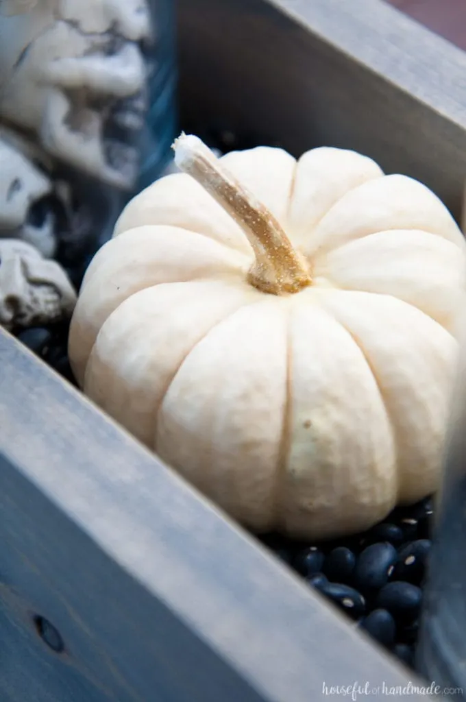 This is the perfect combination of spooky and farmhouse decor. Decorate your dining room table with this easy DIY Halloween centerpiece. Includes a tutorial to make a wooden trough box in minutes. | Housefulofhandmade.com