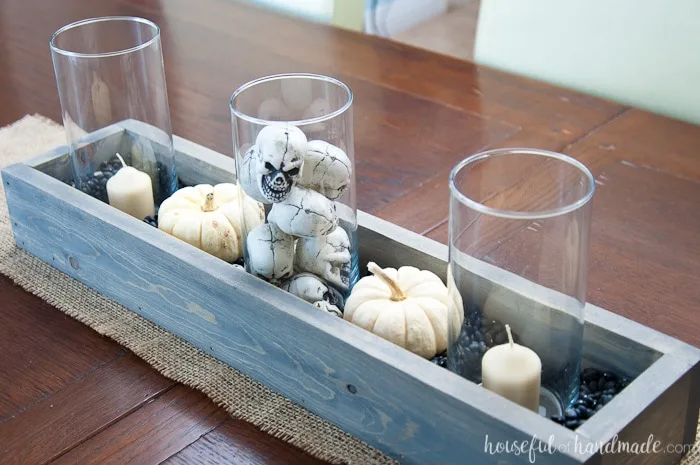 This is the perfect combination of spooky and farmhouse decor. Decorate your dining room table with this easy DIY Halloween centerpiece. Includes a tutorial to make a wooden trough box in minutes. | Housefulofhandmade.com