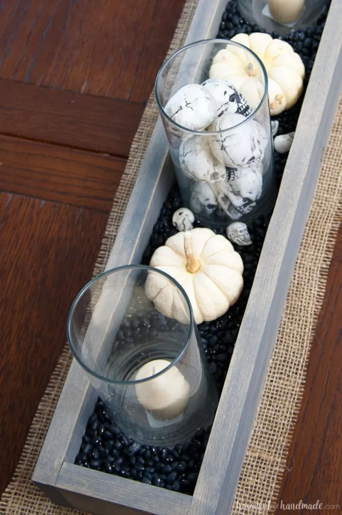 This is the perfect combination of spooky and farmhouse decor. Decorate your dining room table with this easy DIY Halloween centerpiece. Includes a tutorial to make a wooden trough box in minutes. | Housefulofhandmade.com