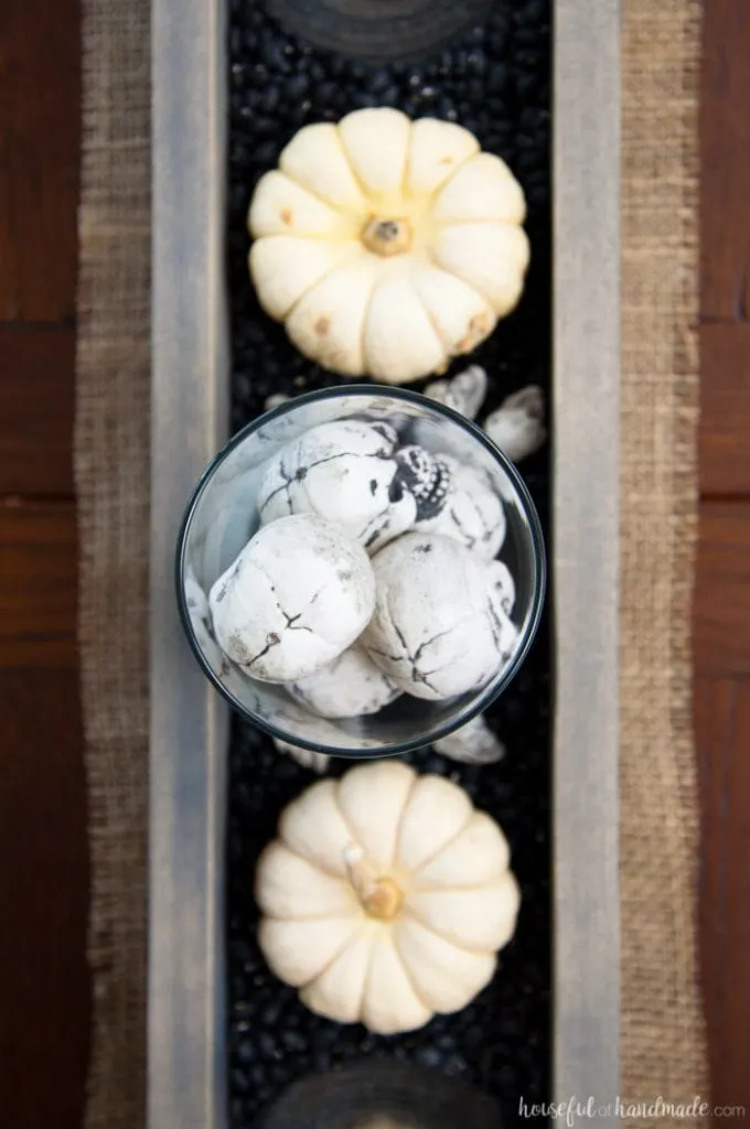 This is the perfect combination of spooky and farmhouse decor. Decorate your dining room table with this easy DIY Halloween centerpiece. Includes a tutorial to make a wooden trough box in minutes. | Housefulofhandmade.com