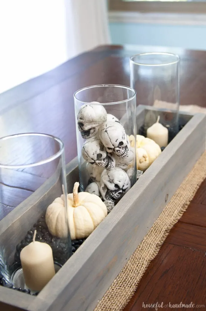 This is the perfect combination of spooky and farmhouse decor. Decorate your dining room table with this easy DIY Halloween centerpiece. Includes a tutorial to make a wooden trough box in minutes. | Housefulofhandmade.com