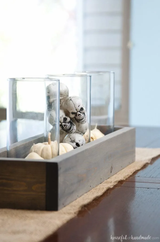 This is the perfect combination of spooky and farmhouse decor. Decorate your dining room table with this easy DIY Halloween centerpiece. Includes a tutorial to make a wooden trough box in minutes. | Housefulofhandmade.com