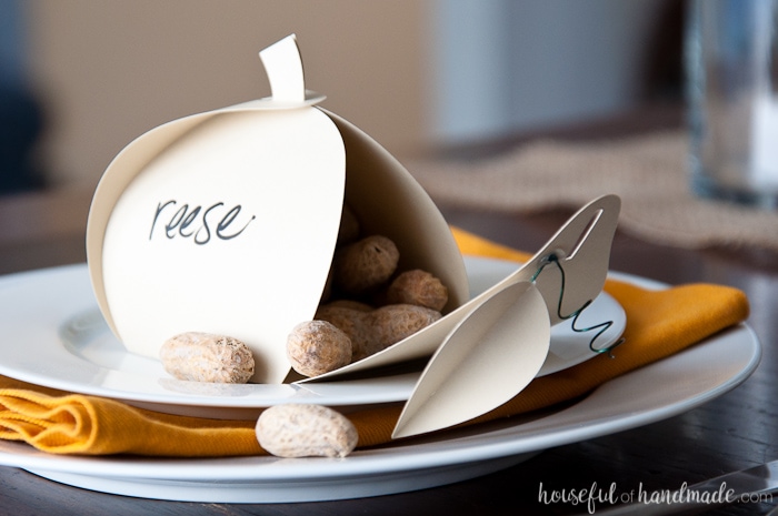 Make Thanksgiving extra festive with these easy Thanksgiving place cards that can be filled with treats for an easy appetizer. These paper pumpkin boxes are easy to make and will leave your guests feeling extra special this holiday season. | Housefulofhandmade.com
