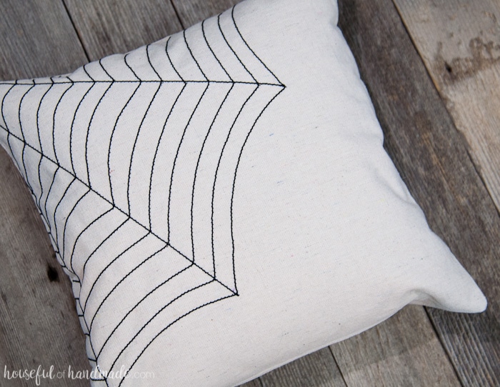 Love this simple pillow for Halloween! Celebrate October with this easy DIY farmhouse style spiderweb throw pillow made out of drop cloth and nylon string. It's simple rustic decor that will fit in with your current decor, but with a spooky touch. | Housefulofhandmade.com