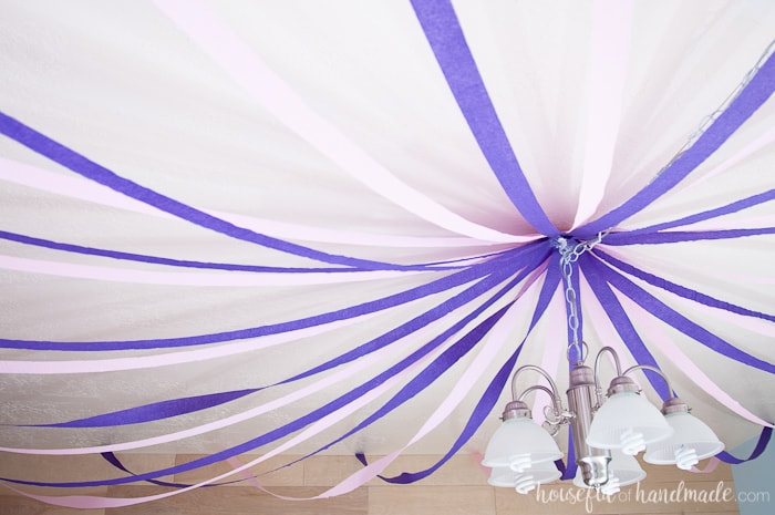 streamers on the ceiling as a decoration for a masquerade ball themed birthday