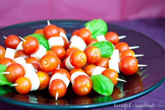 mini caprese kabobs on a plate for a masquerade ball themed birthday