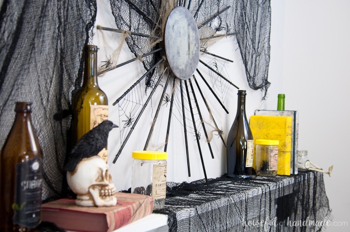 I love this mantle decor! Create a spooky apothecary Halloween mantle with easy DIY decorations. Spooky apothecary jars, bloody candles, and potions books make this the perfect spooky Halloween decor. | Housefulofhandmade.com