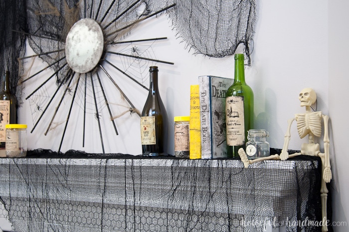 I love this mantle decor! Create a spooky apothecary Halloween mantle with easy DIYs. Spooky apothecary jars, bloody candles, and potions books make this the perfect spooky Halloween decor ever. | Housefulofhandmade.com