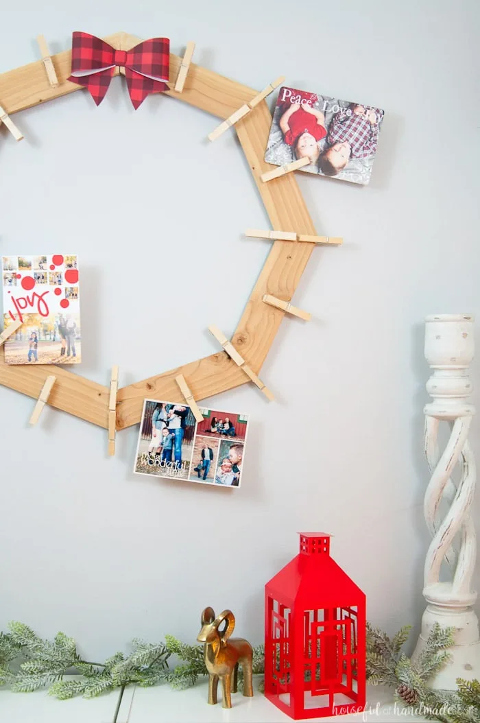 DIY wood Christmas card wreath from 1 1x3 board shown hanging on all with photo cards.
