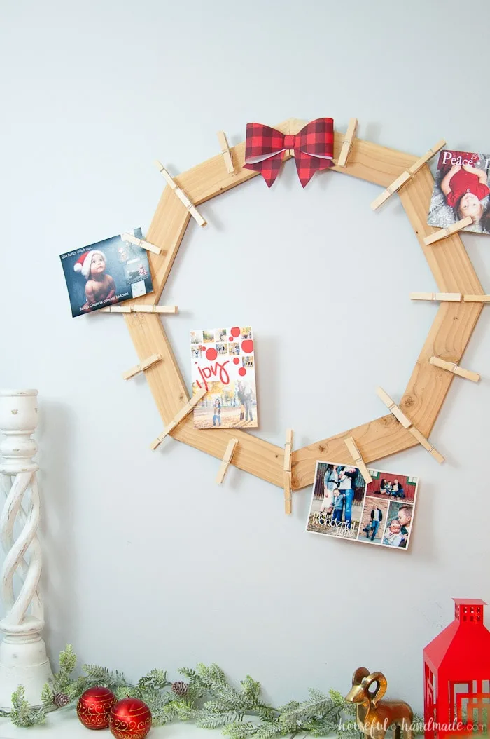 diy rustic farmhouse style Christmas card holder hanging on wall with photo cards