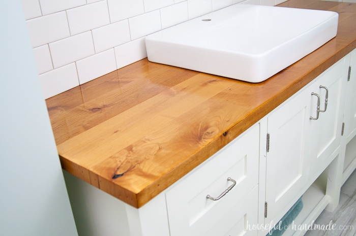 Alder wood vanity top sealed to protect it from water with white sink on top. 