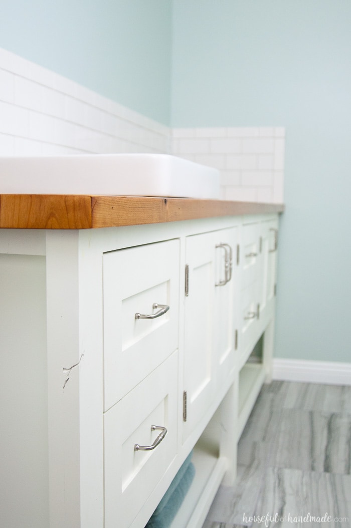 White mission style bathroom vanity with DIY wood vanity top.