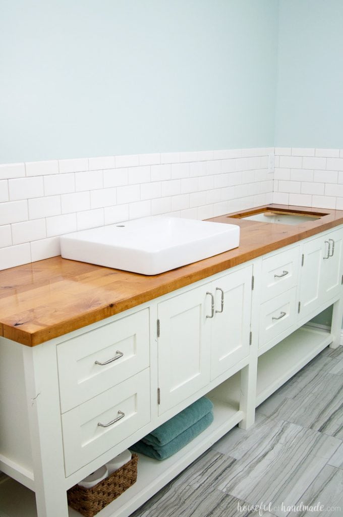 I absolutely love the look of this bathroom vanity! Add some rustic warmth to your farmhouse bathroom by adding a waterproof wood vanity top. Learn how to build & protect a wood vanity top for your next DIY renovation. | Housefulofhandmade.com