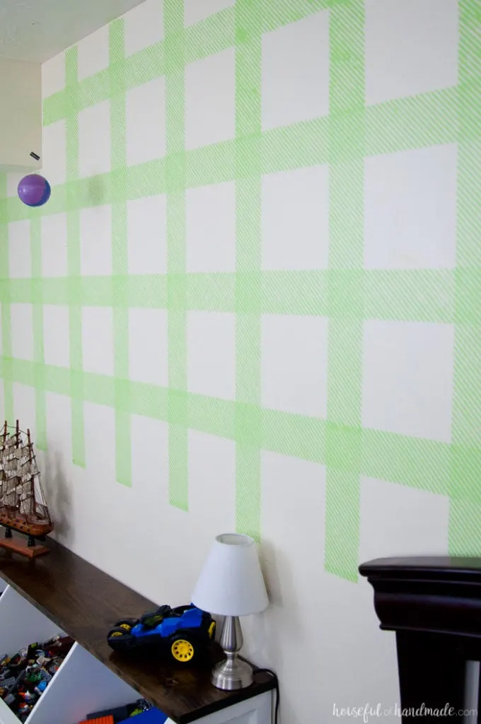 Create an awesome feature wall for your boy's room with this DIY plaid wall. Learn how to make your own stencil and paint it with all these great stencil tips & tricks. | Housefulofhandmade.com