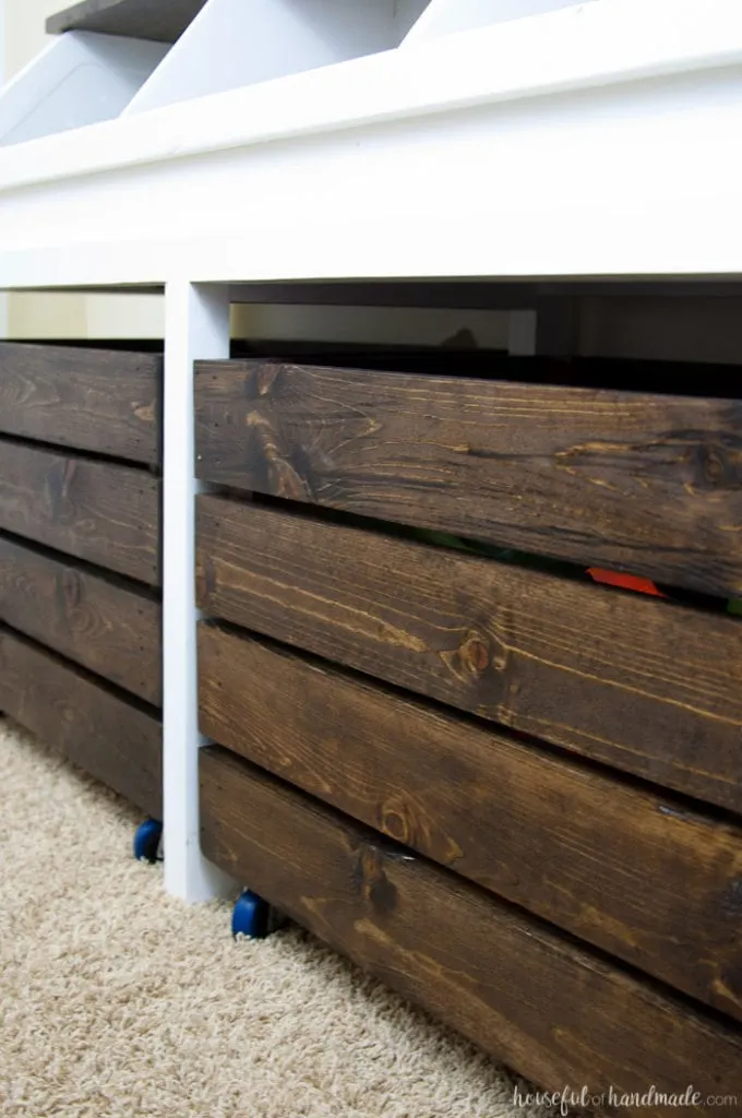 close up of the rolling storage boxes of the diy rustic toy box