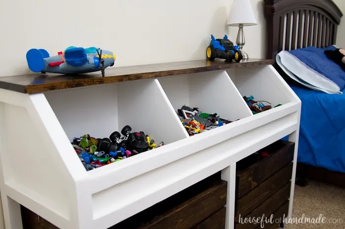 toy storage unit with bed in back round