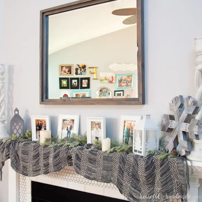 Large decorative mirrors are so expensive but make such an impact on your home decor. See how easy it is to make a DIY rustic mirror from just a few boards and an inexpensive mirror. I actually made it completely out of wood scraps. | Housefulofhandmade.com