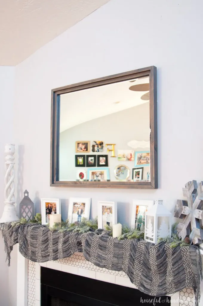 Large decorative mirrors are so expensive but make such an impact on your home decor. See how easy it is to make a DIY rustic mirror from just a few boards and an inexpensive mirror. I actually made it completely out of wood scraps. | Housefulofhandmade.com