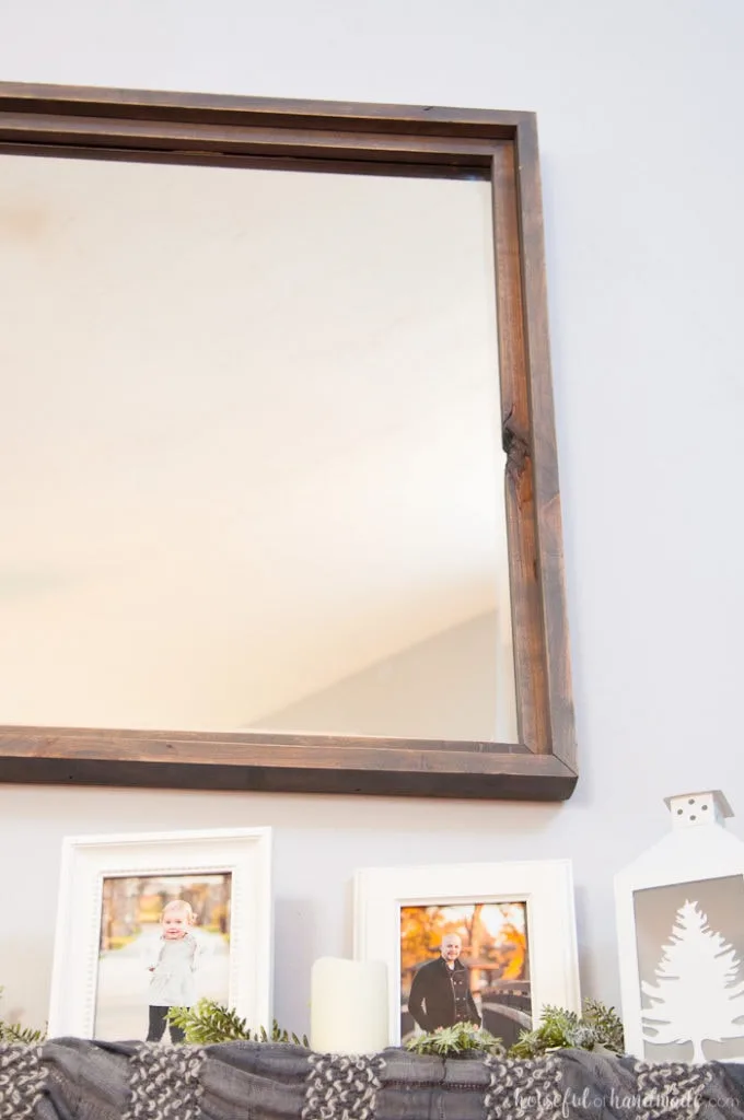 Large decorative mirrors are so expensive but make such an impact on your home decor. See how easy it is to make a DIY rustic mirror from just a few boards and an inexpensive mirror. I actually made it completely out of wood scraps. | Housefulofhandmade.com