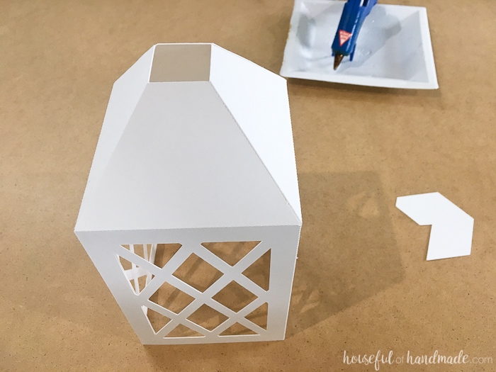 paper lantern being glued together with hot glue gun