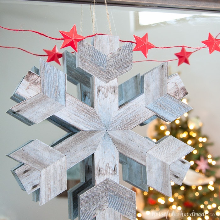 If you don't like power tools you can still get these perfect wood snowflakes for your winter decor. This easy faux wooden snowflake decor is made out of paper but looks just like real wood. Make a bunch to decorate your Christmas tree or winter mantle. | Housefulofhandmade.com