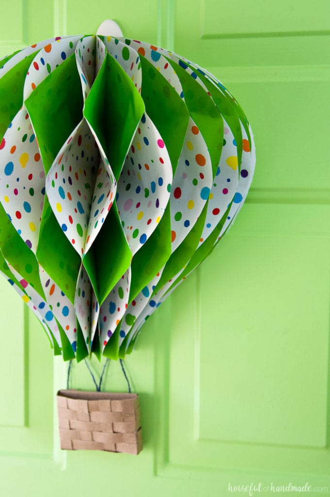 Make a paper hot air balloon spring wreath to brighten up your front door this spring! Housefulofhandmade.com | Unique wreath ideas | Spring Wreath | Summer Wreath | Paper Crafting | DIY Hot Air Balloon | Paper Decor | DIY Wreath