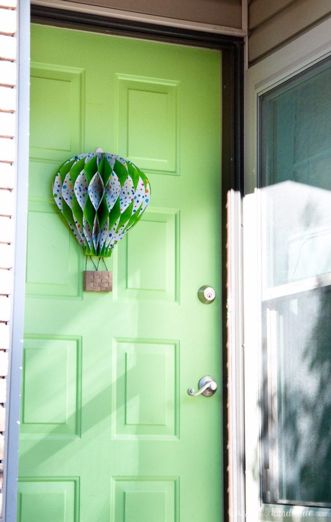 Make a paper hot air balloon spring wreath to brighten up your front door this spring! Housefulofhandmade.com | Unique wreath ideas | Spring Wreath | Summer Wreath | Paper Crafting | DIY Hot Air Balloon | Paper Decor | DIY Wreath