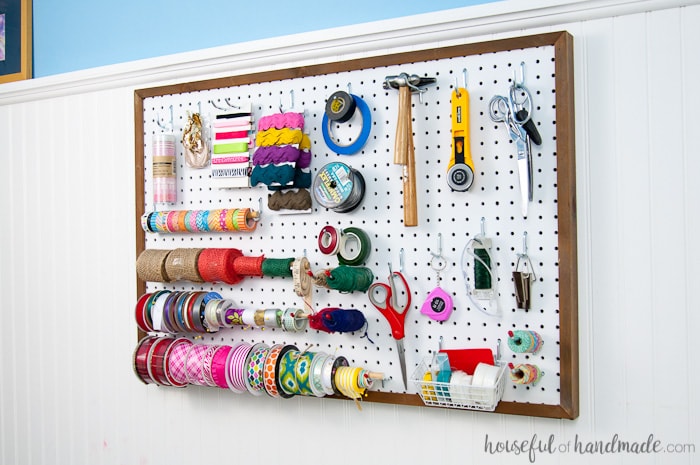 Use these amazing DIYs to Organize your home this year. Create the perfect place to organize your most used supplies! Learn how to hang pegboard so it is removable if needed. Housefulofhandmade.com | Craft organization ideas | Craft room remodel | Pegboard organization | $100 Room Challenge | Easy woodworking | Easy building plans | Free Building plans