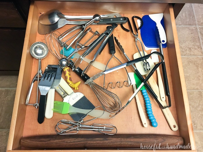 standard kitchen drawer with unorganized utensils