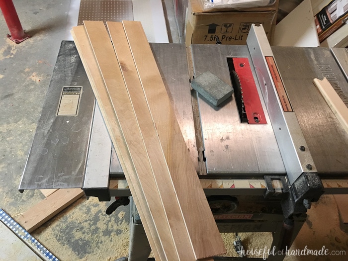 scraps of wood on a table saw before assembling vinyl kitchen utensil drawings and organizer