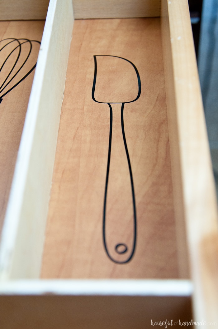 open drawer with vinyl drawing of a kitchen spatula