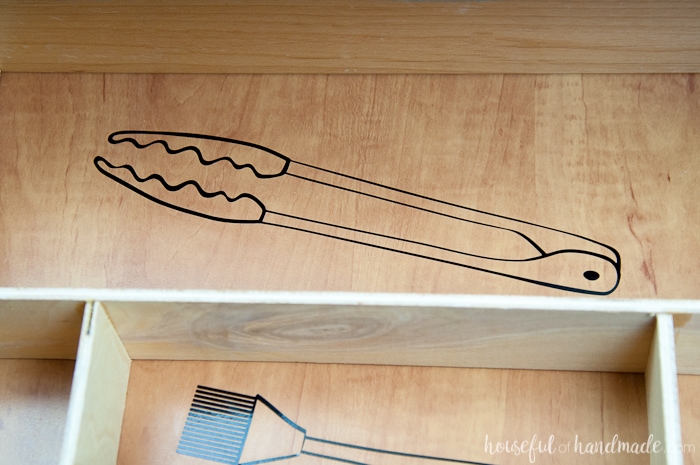 close up image of vinyl kitchen utensil drawings in a drawer