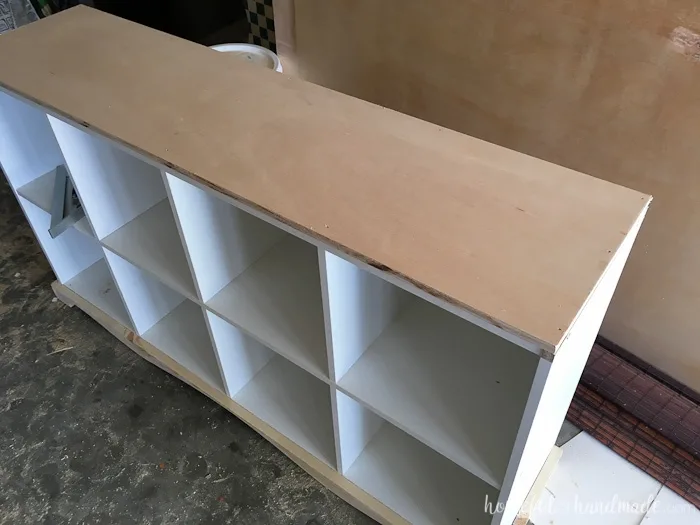 Adding a new wood top to the upcycled cube bookcase.