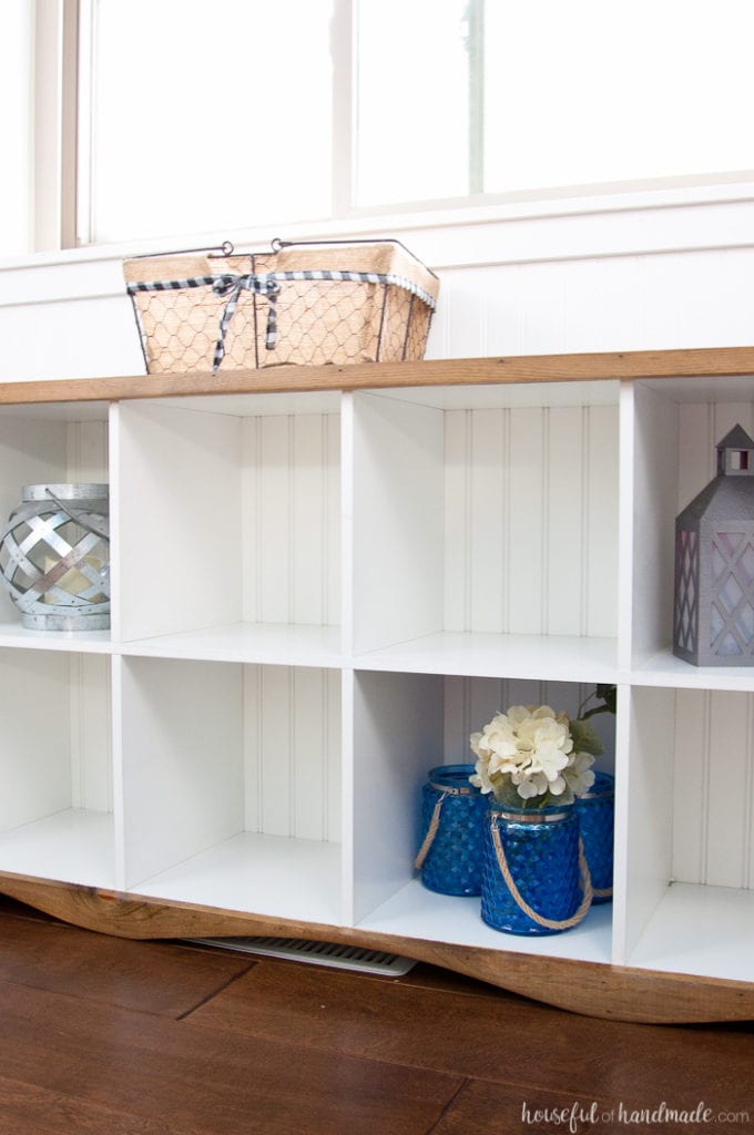 Finished DIY cube bookcase upcycle with lanterns and jars in some of the cubes.