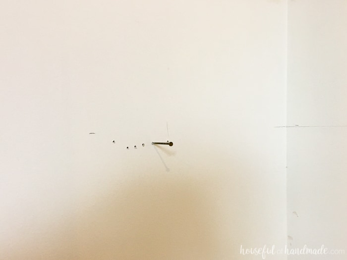 closet wall shown with nail as marking for desk placement