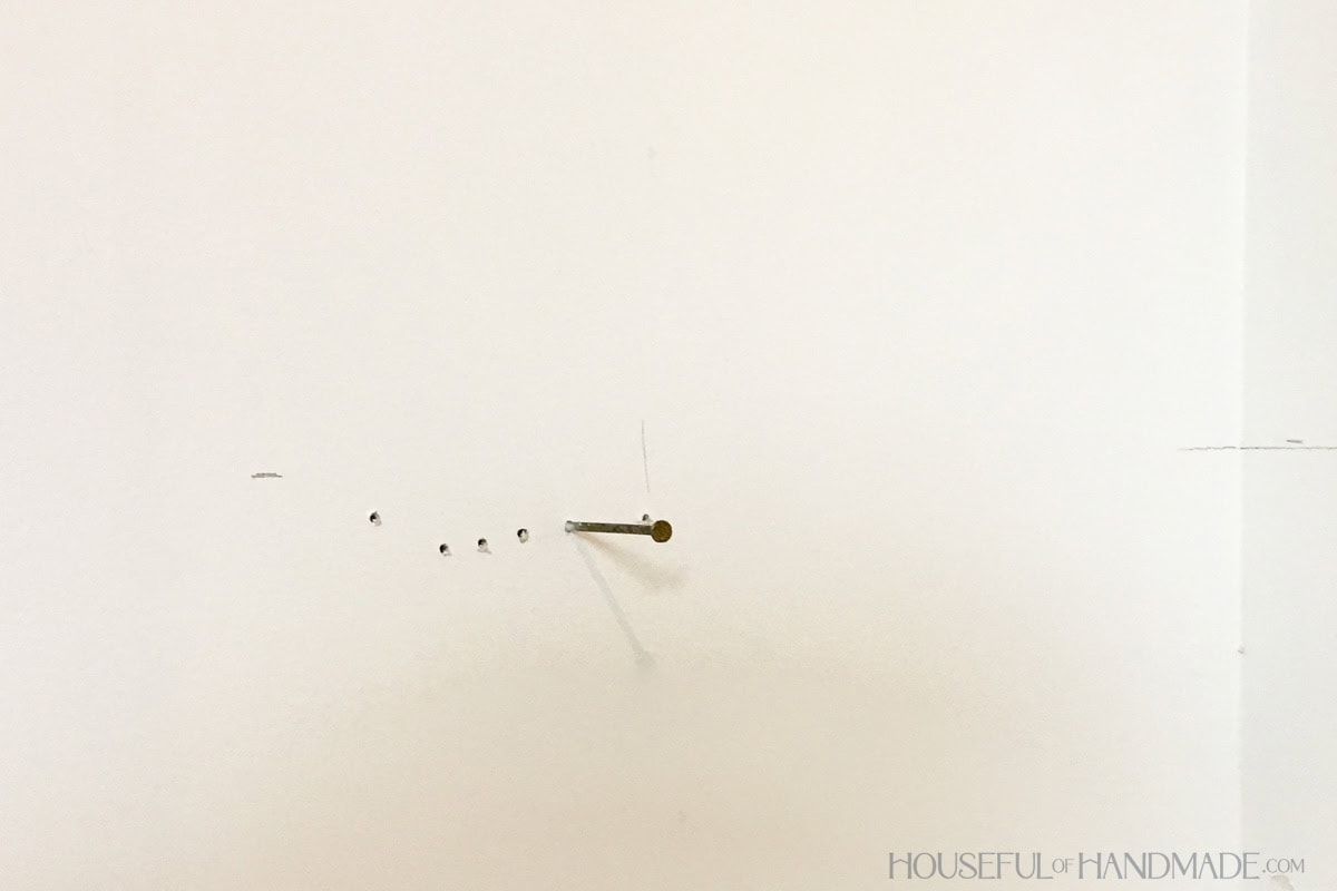 Closet wall with nail used to find studs.