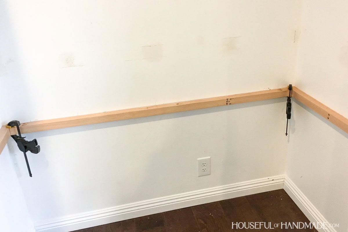 Sides and back of desk frame built into a nook with 2x2 boards.