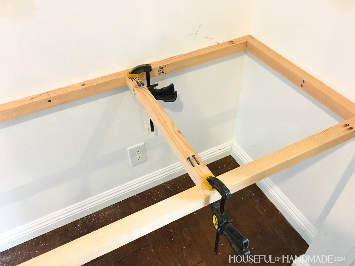 Inside of closet with desk frame and center braces attached to the frame with pocket holes.
