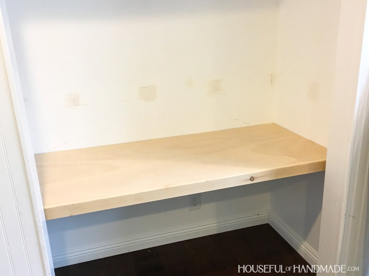 Desk top built inside closet prior to staining and painting walls.