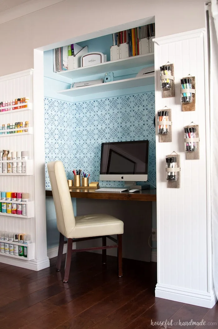 Chic farmhouse style office & craft room with a desk in the closet and creative storage around it. 