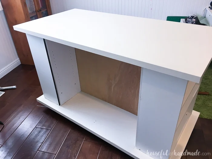 Don't throw out those old cheap bookcases from your college days, upcycle them into the perfect work station. Create this amazing upcycled bookcase rolling work table for your craft room or office. | Housefulofhandmade.com || Craft Table | Rolling Work Table | Upcycled Bookcase | Craft Room Storage | Free Build Plans