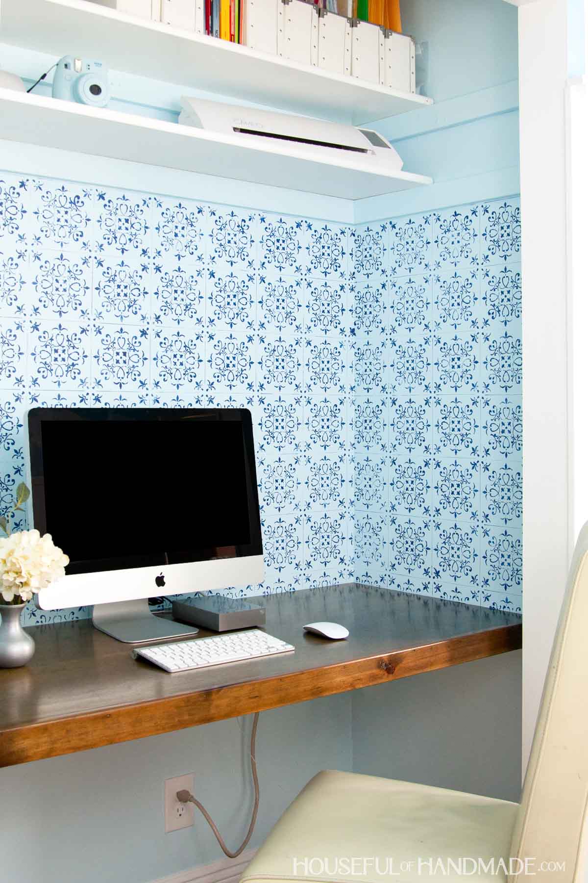 Budget friendly desk built in closet with book shelves, computer wood desk and chair with computer on desk top.