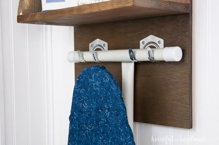 Create the perfect place to store your iron and supplies. This easy DIY Iron Holder with Ironing Board Storage is a quick build that will keep your laundry room or craft room organized. Free build plans on Housefulofhandmade.com | Laundry Room Storage Ideas | Ironing Board Hanger | Iron Shelf | Things to Build with Scraps | $100 Room Challenge