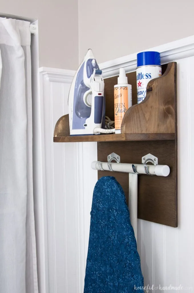 Create the perfect place to store your iron and supplies. This easy DIY Iron Holder with Ironing Board Storage is a quick build that will keep your laundry room or craft room organized. Free build plans on Housefulofhandmade.com | Laundry Room Storage Ideas | Ironing Board Hanger | Iron Shelf | Things to Build with Scraps | $100 Room Challenge