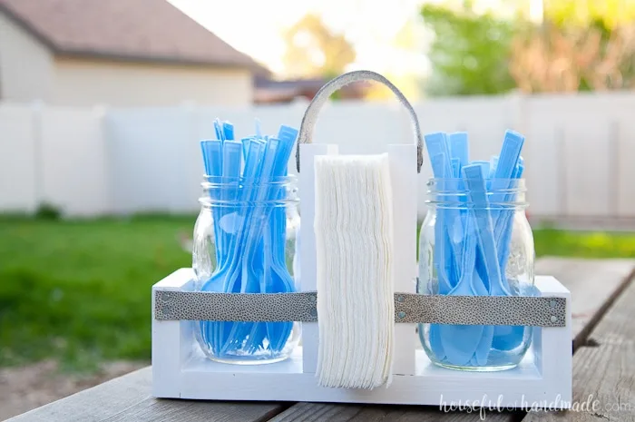 Get ready for summer BBQ season with this DIY utensil caddy with mason jars. It's perfect to hold everything you need for entertaining outside, it even has a spot to keep your napkins from blowing away. Super easy to build. Housefulofhandmade.com | Free build plans | 20 Minute Crafts | DIY Silverware Holder | Mason Jar Crafts | Scrap Wood Projects