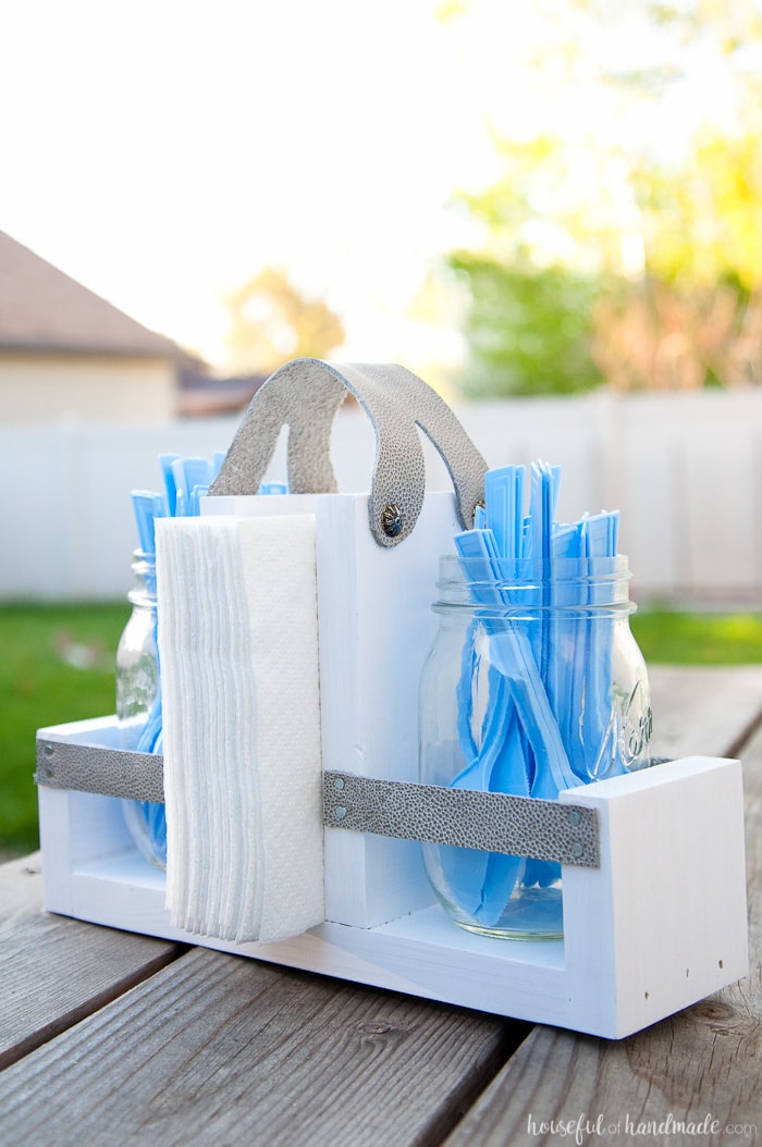 Get ready for summer BBQ season with this DIY utensil caddy with mason jars. It's perfect to hold everything you need for entertaining outside, it even has a spot to keep your napkins from blowing away. Super easy to build. Housefulofhandmade.com | Free build plans | 20 Minute Crafts | DIY Silverware Holder | Mason Jar Crafts | Scrap Wood Projects