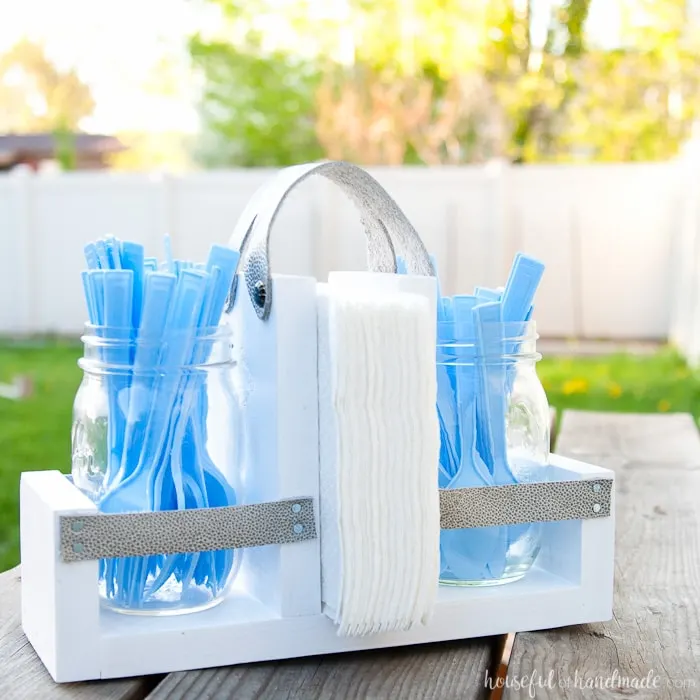 Get ready for summer BBQ season with this DIY utensil caddy with mason jars. It's perfect to hold everything you need for entertaining outside, it even has a spot to keep your napkins from blowing away. Super easy to build. Housefulofhandmade.com | Free build plans | 20 Minute Crafts | DIY Silverware Holder | Mason Jar Crafts | Scrap Wood Projects