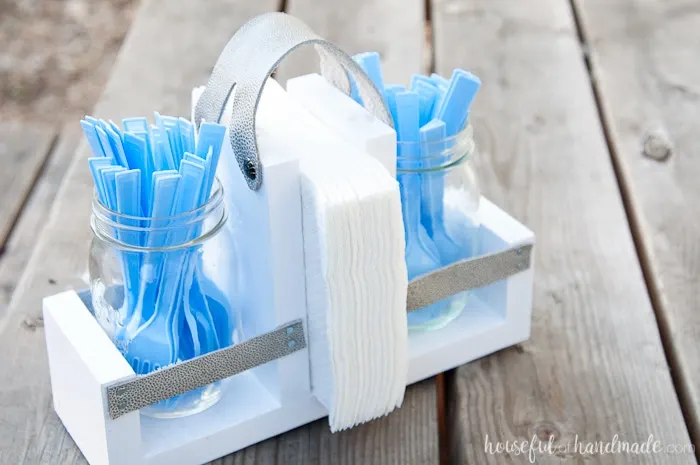 Get ready for summer BBQ season with this DIY utensil caddy with mason jars. It's perfect to hold everything you need for entertaining outside, it even has a spot to keep your napkins from blowing away. Super easy to build. Housefulofhandmade.com | Free build plans | 20 Minute Crafts | DIY Silverware Holder | Mason Jar Crafts | Scrap Wood Projects