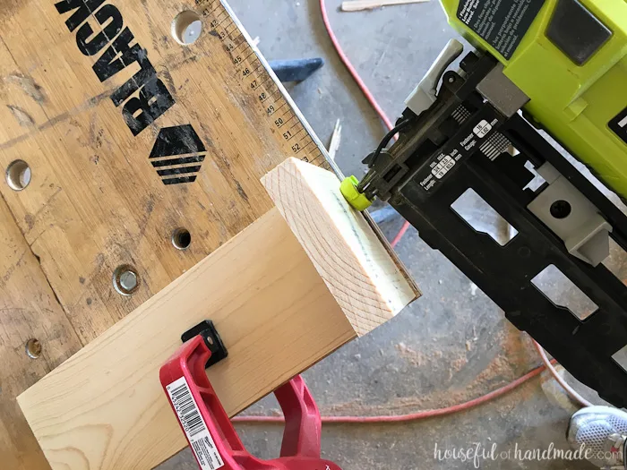 Attaching the side to the silverware caddy with a nail gun. 